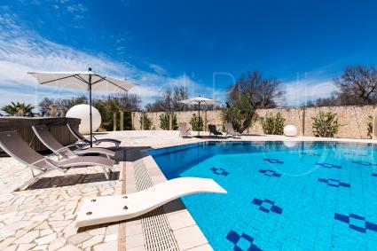 The pool is furnished with loungers and deckchairs for relaxation
