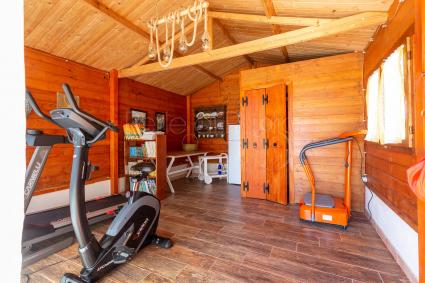 Lovely gym in the wooden house by the swimming pool